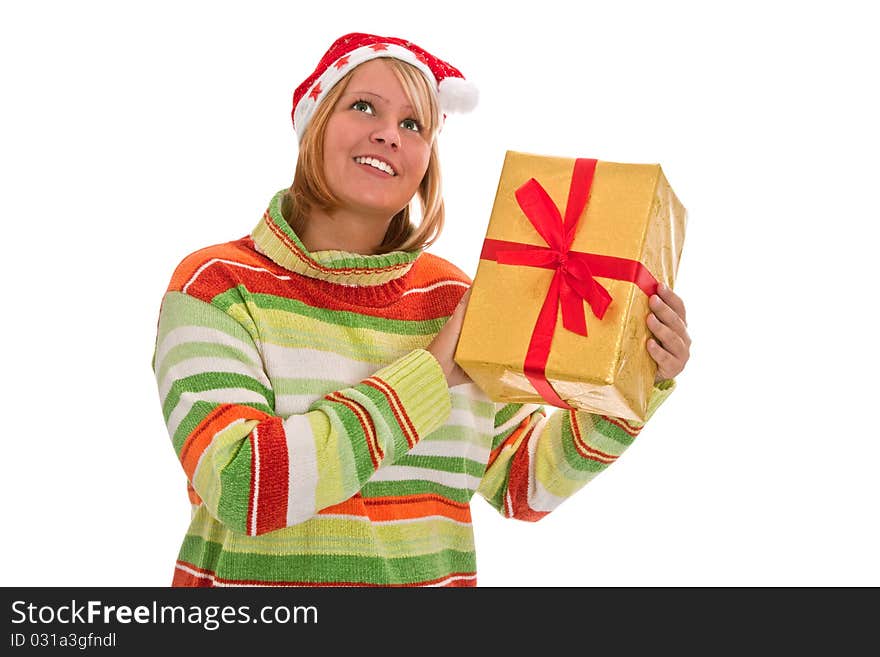 Young woman with santa hat holding a golden christmas gift - isolated. Young woman with santa hat holding a golden christmas gift - isolated