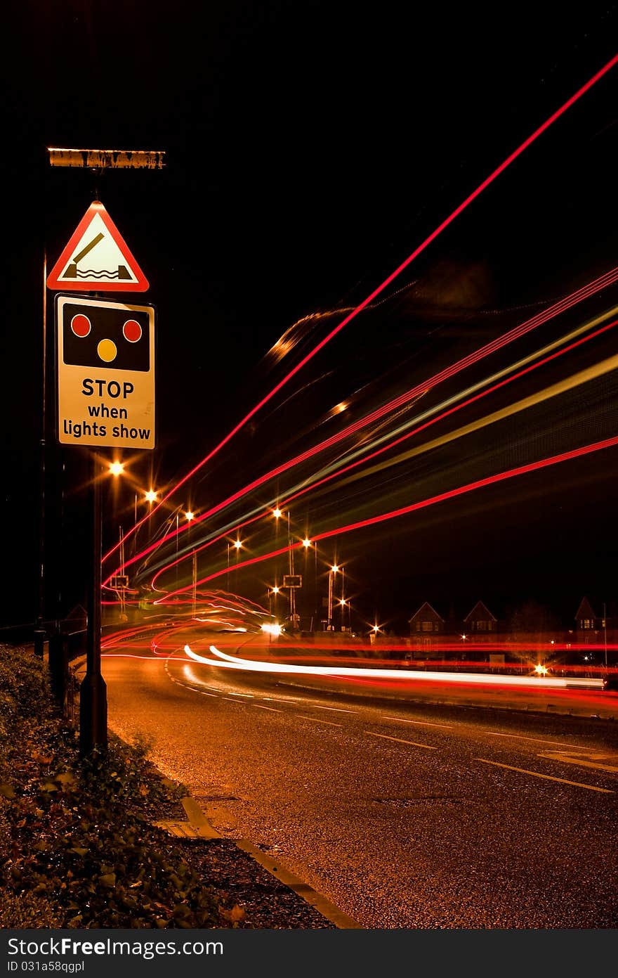 A night shot taken with long exposure to show the streaming light trails.Road sign in the forground for interest. A night shot taken with long exposure to show the streaming light trails.Road sign in the forground for interest.