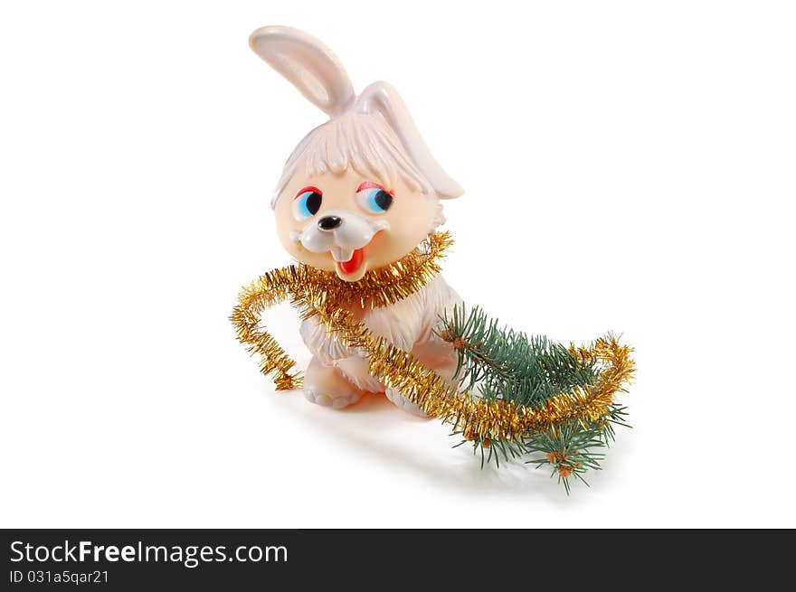 The rabbit with a fur-tree branch is isolated on a white background