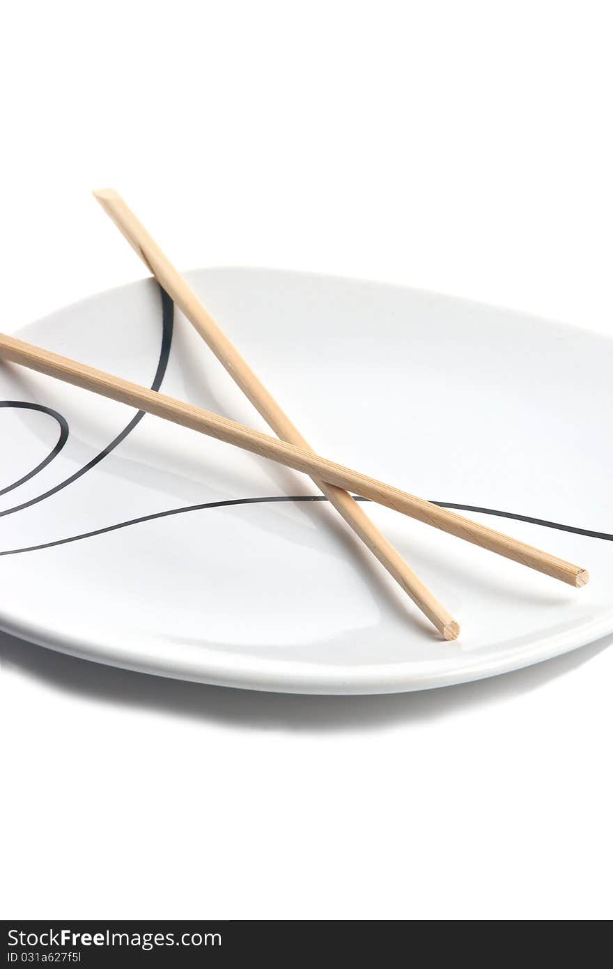 Wood chopsticks and asian style plate against white background. Wood chopsticks and asian style plate against white background