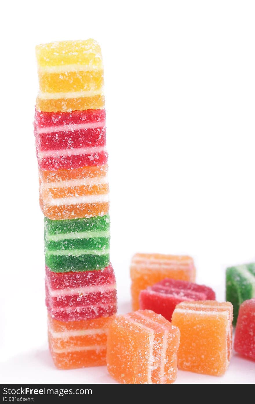 Vertical stack of colorful marmalade candies isolated on white background