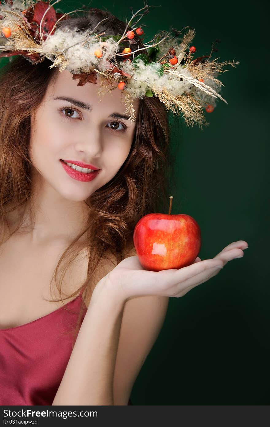 Girl in natural wreath with apple