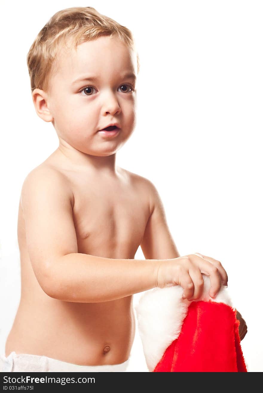 Little boy prepares to put on Santa's hat. Little boy prepares to put on Santa's hat