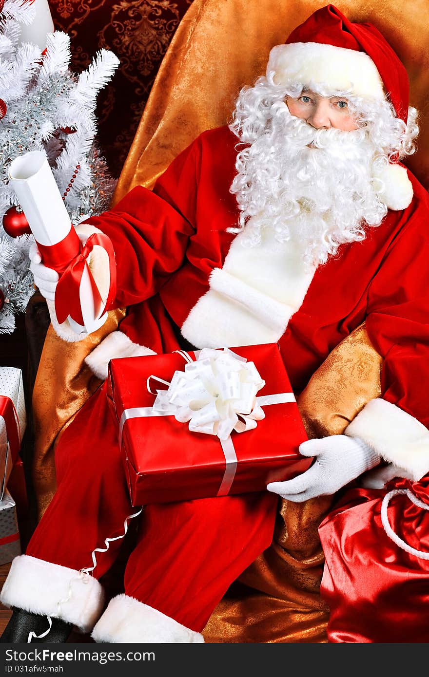 Santa Claus with presents and New Year tree at home. Christmas. Santa Claus with presents and New Year tree at home. Christmas.