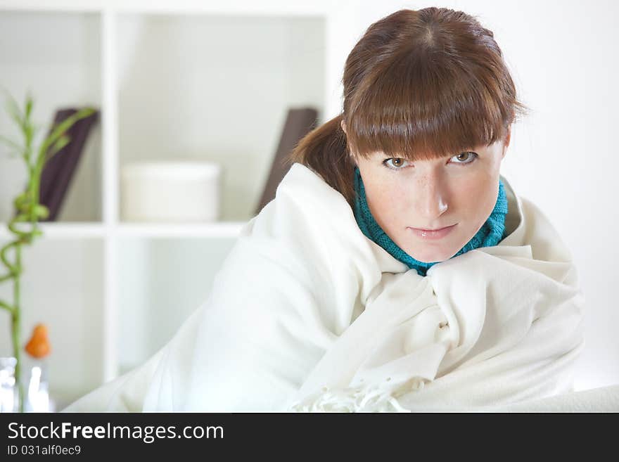 Woman covering with rug on sofa