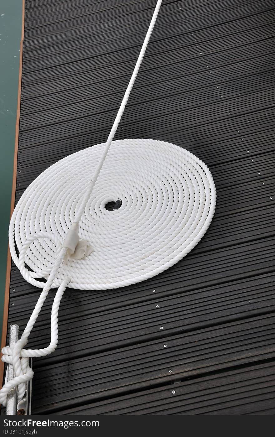 Twist Rope Of Boat On Dock Board