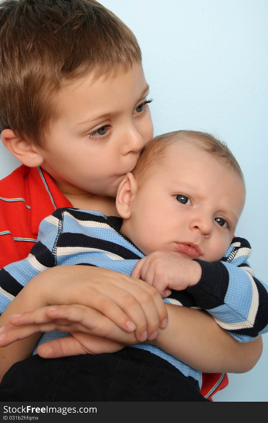 Beautiful boy with his two month old baby brother. Beautiful boy with his two month old baby brother