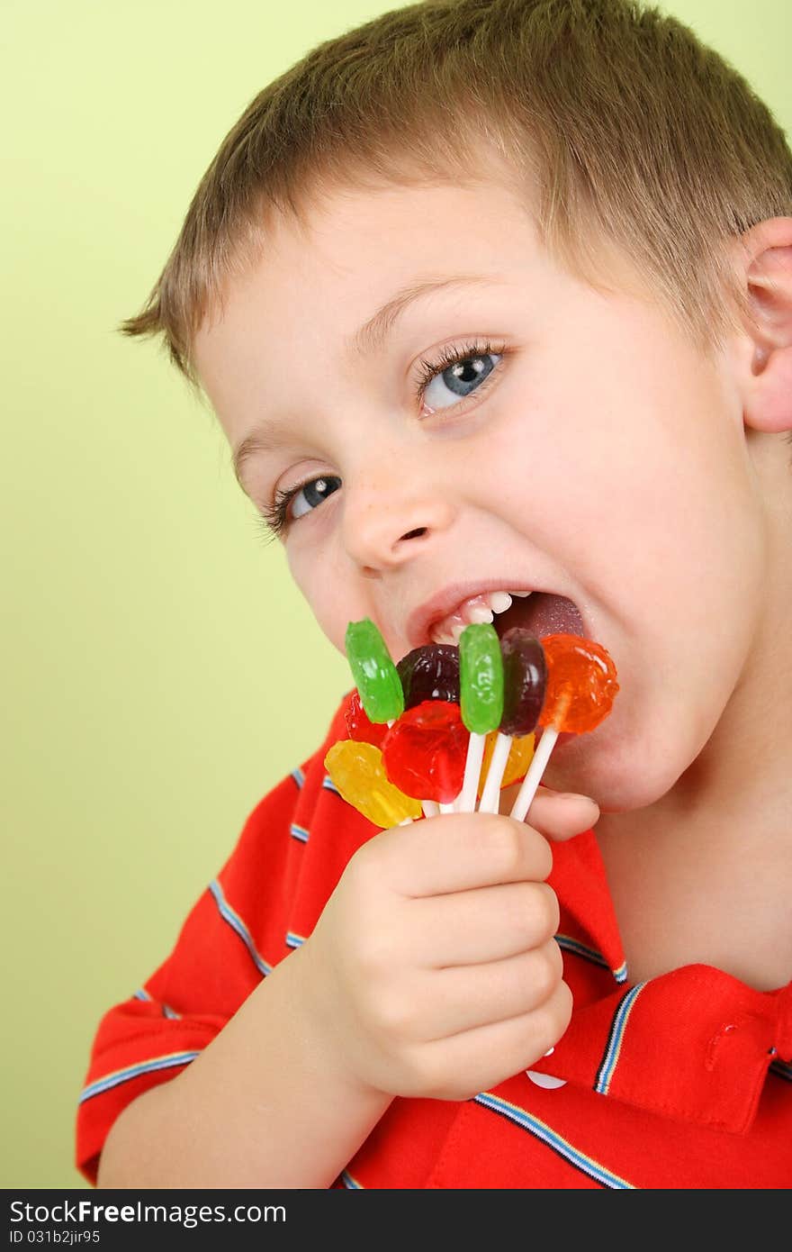 Beautiful blond boy with hand full of lollies. Beautiful blond boy with hand full of lollies