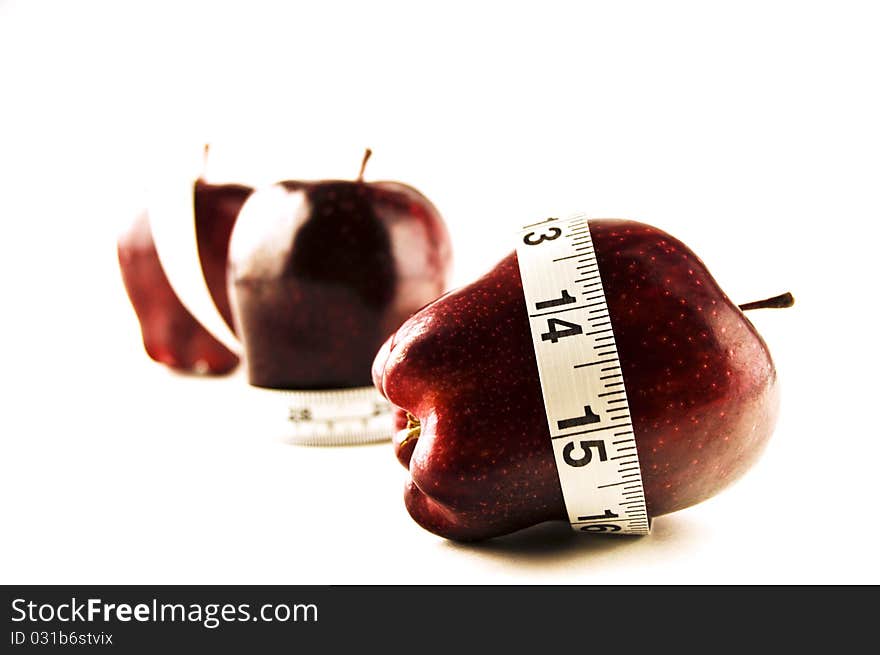 Apple and measure tape on a white background. Apple and measure tape on a white background