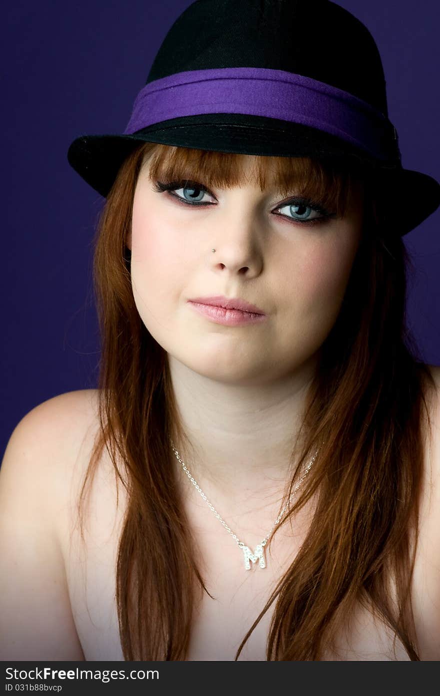 Young model wearing black and purple hat. Young model wearing black and purple hat