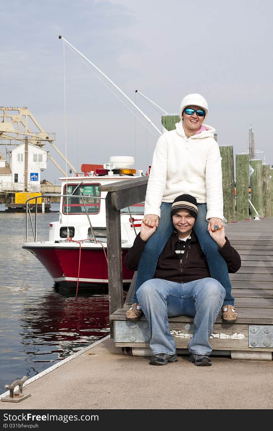 Happy couple having fun at a pier. Lifestyle of a happy couple.