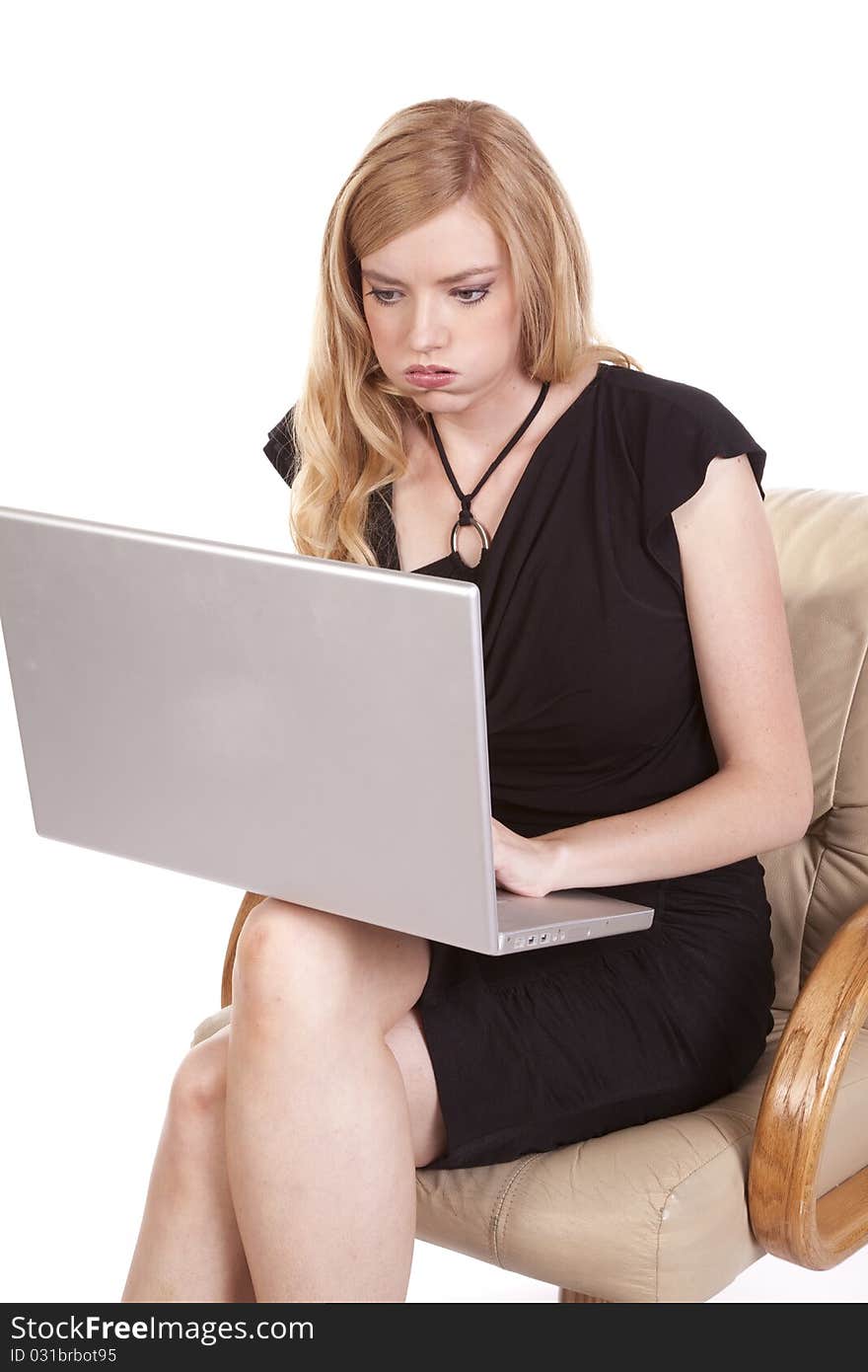 A woman working on her laptop taking a deep breath. A woman working on her laptop taking a deep breath.