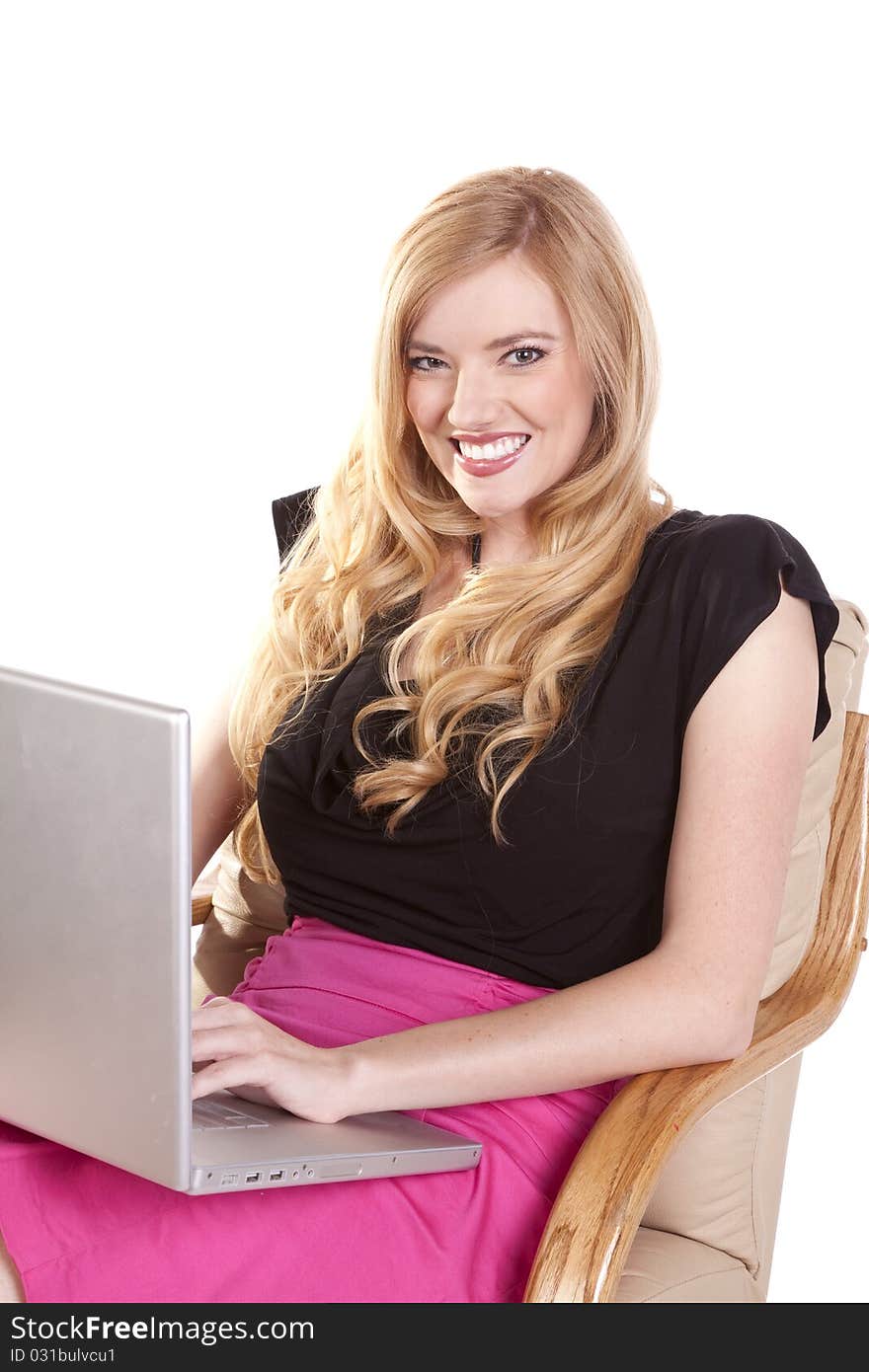 A woman showing her happy expression while she is working on her laptop. A woman showing her happy expression while she is working on her laptop.