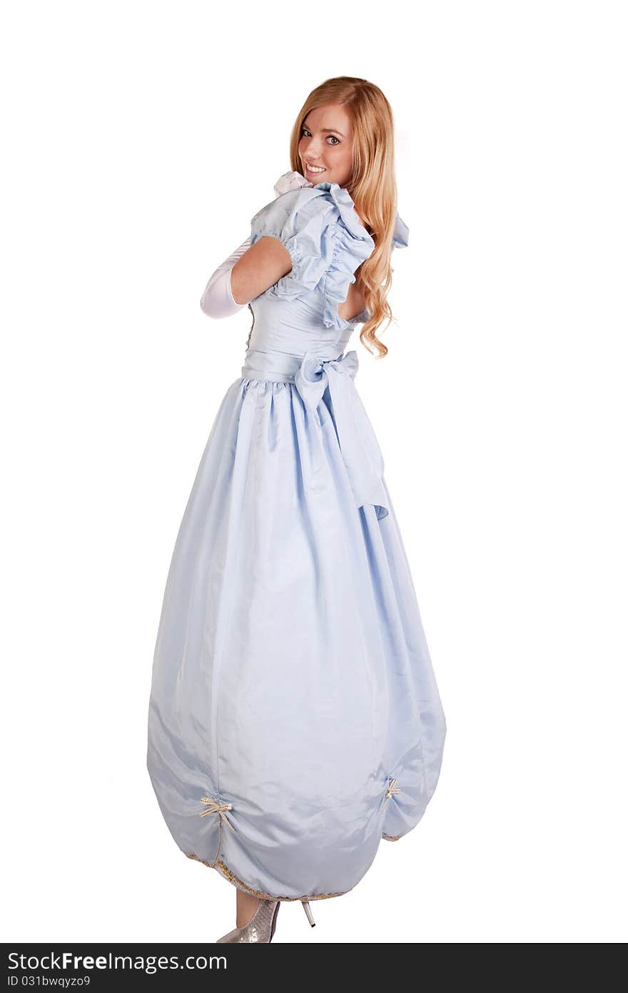 A woman in her beautiful blue princess dress looking over her shoulder with a smile on her face. A woman in her beautiful blue princess dress looking over her shoulder with a smile on her face.