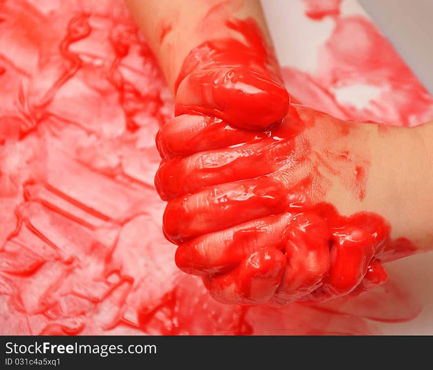 Child Hands Painted In Red Paint