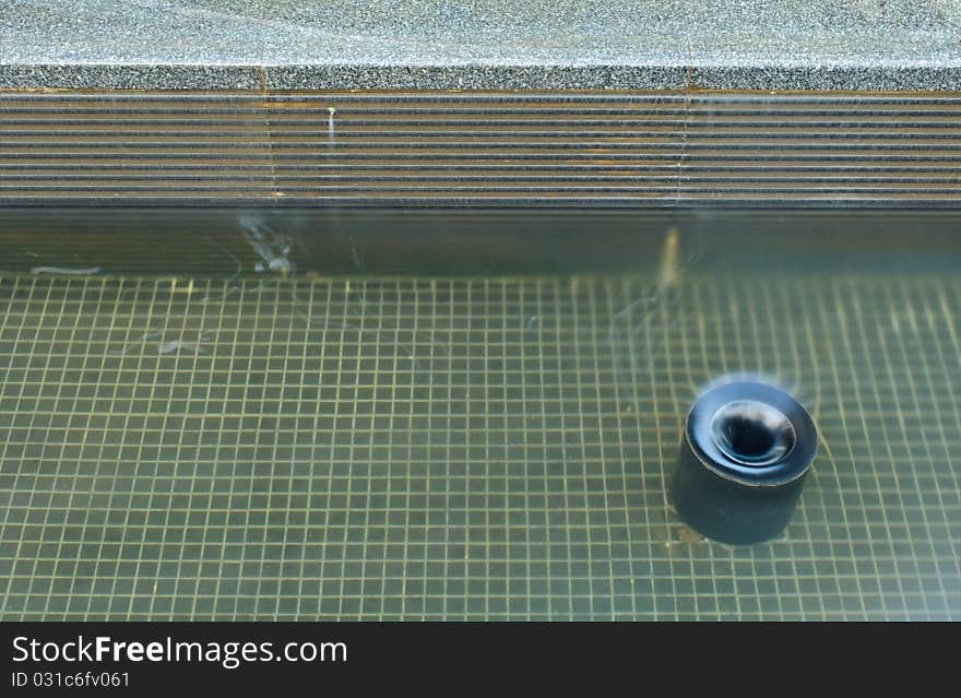 A huge water drain in a pool.