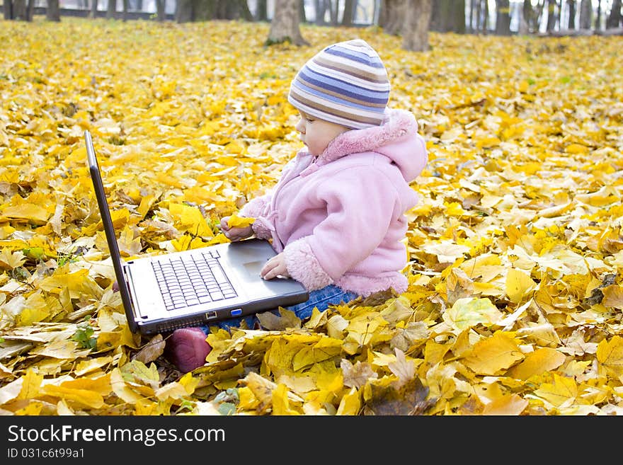 Little girl looking into a laptop. Little girl looking into a laptop