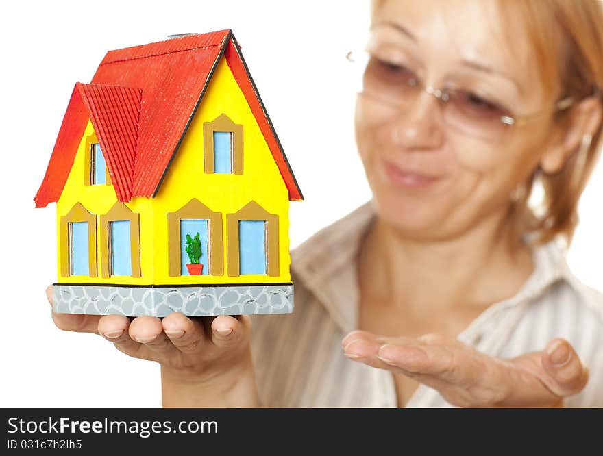 Female hands holding concept house. Selective focus on the house. Female hands holding concept house. Selective focus on the house