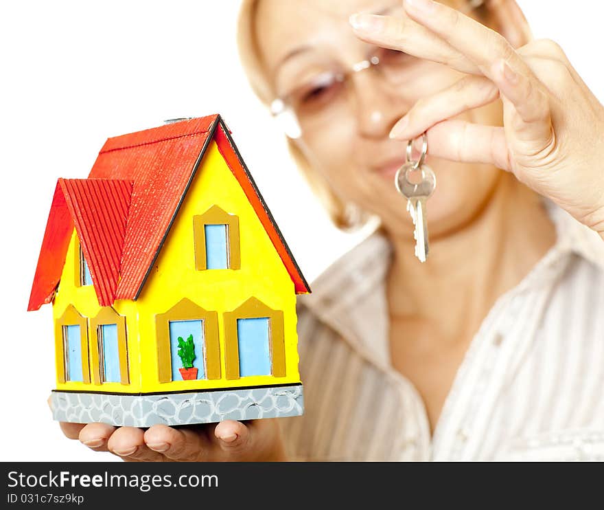 Female hands holding concept house. Selective focus on the house. Female hands holding concept house. Selective focus on the house