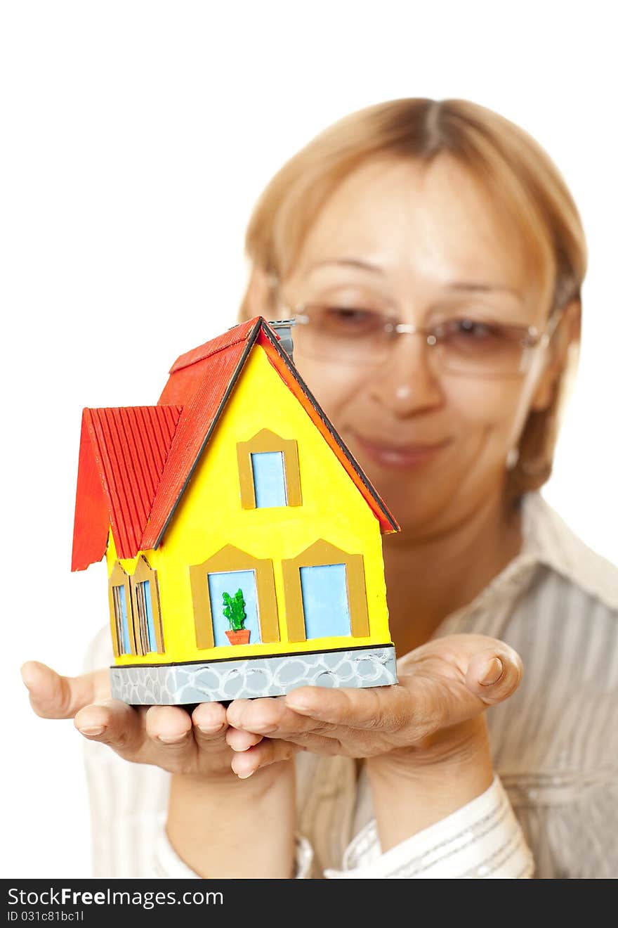 Female hands holding concept house. Selective focus on the house. Female hands holding concept house. Selective focus on the house