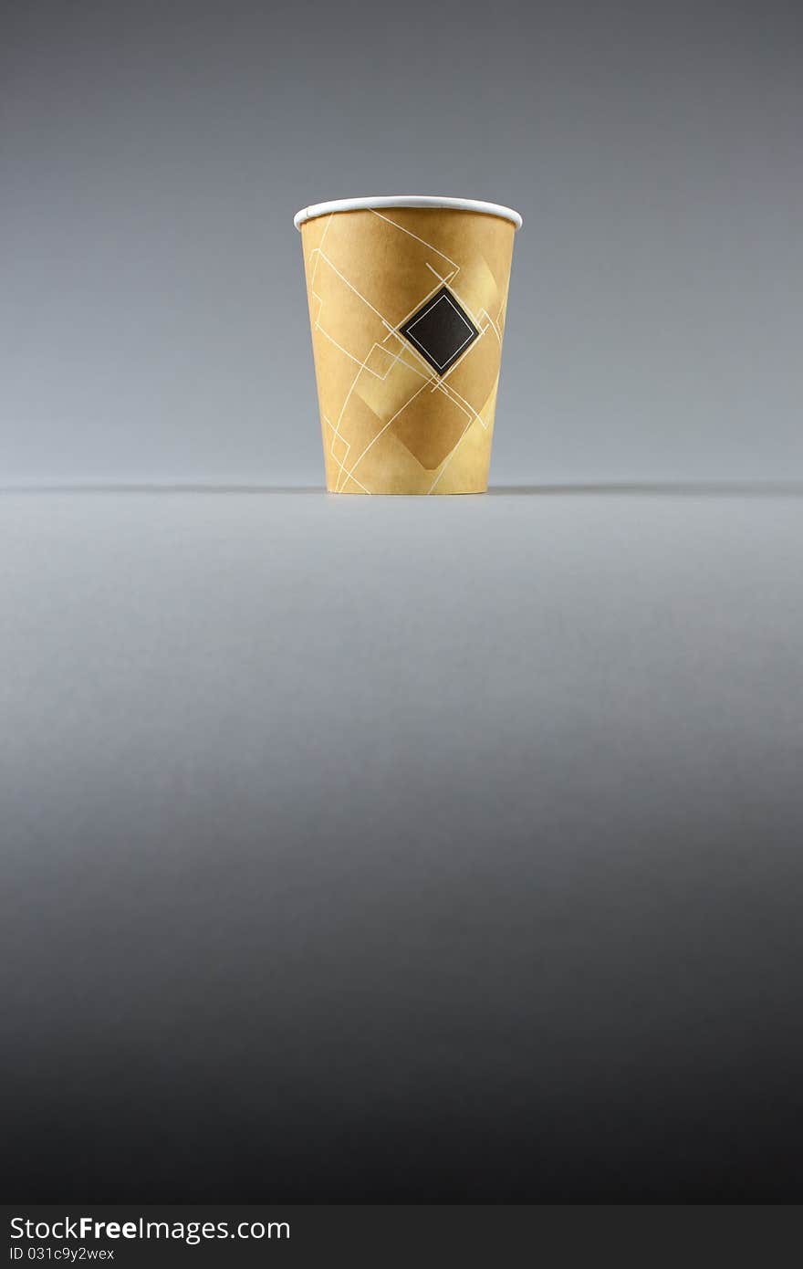 Yellow paper cup on grey