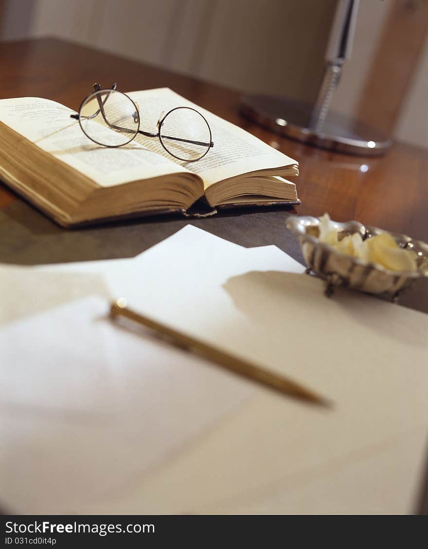 Ancient paper and book on antique wooden table -