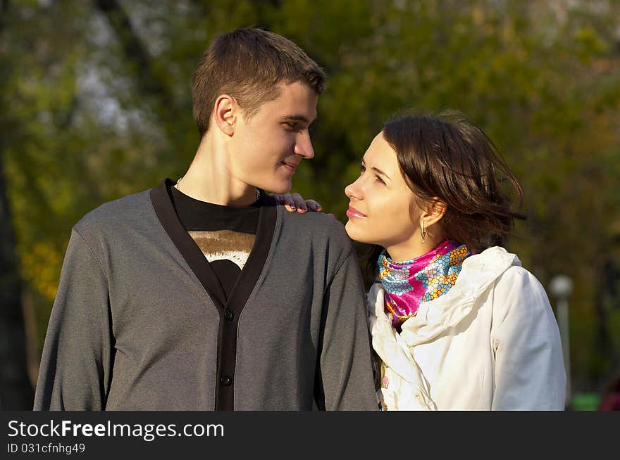 Young couple looking at each other eyes over defocused background. Young couple looking at each other eyes over defocused background