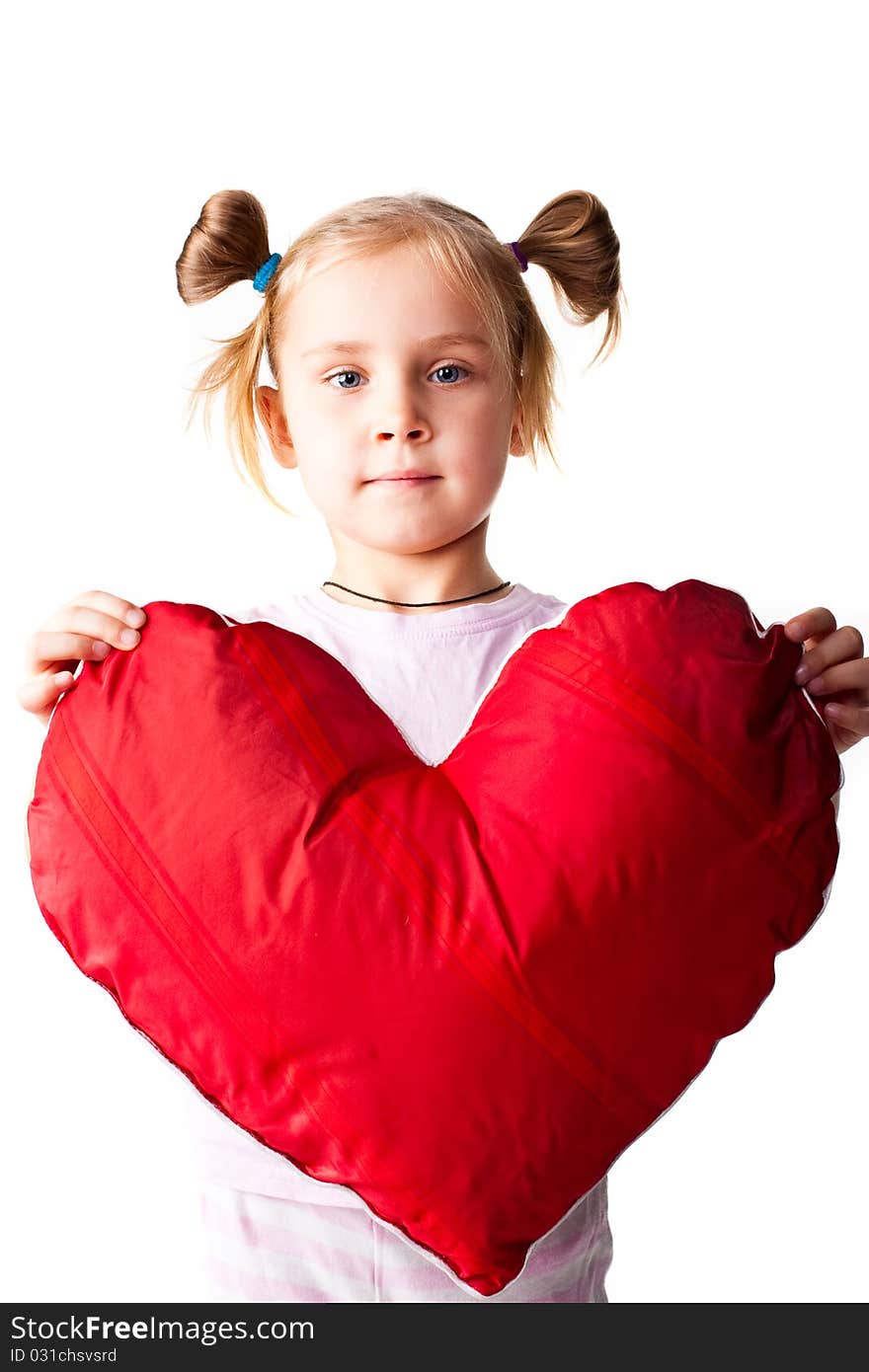 Beautiful girl with heart shaped pillow isolated on white. Beautiful girl with heart shaped pillow isolated on white