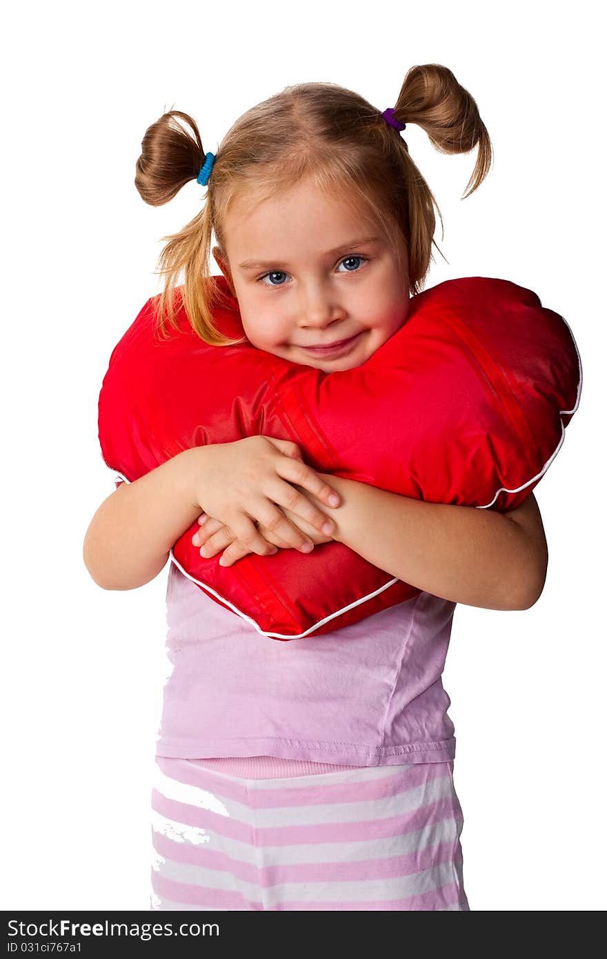 Beautiful girl with heart shaped pillow isolated on white