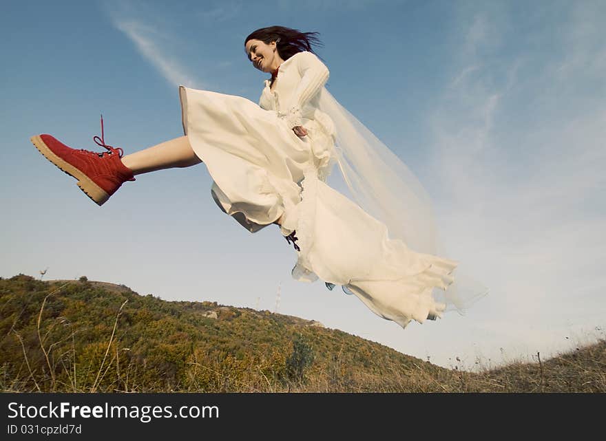 Portrait of romantic woman jumping on field. Portrait of romantic woman jumping on field