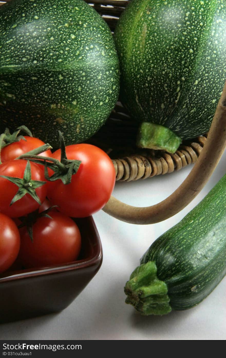 Basket of tomatoes and organic zucchinis