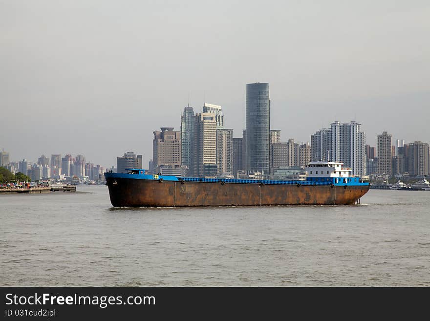 Shanghai / China: Nautical vessel pass modern skyline of Shanghai on Huang Pu River. Shanghai / China: Nautical vessel pass modern skyline of Shanghai on Huang Pu River.