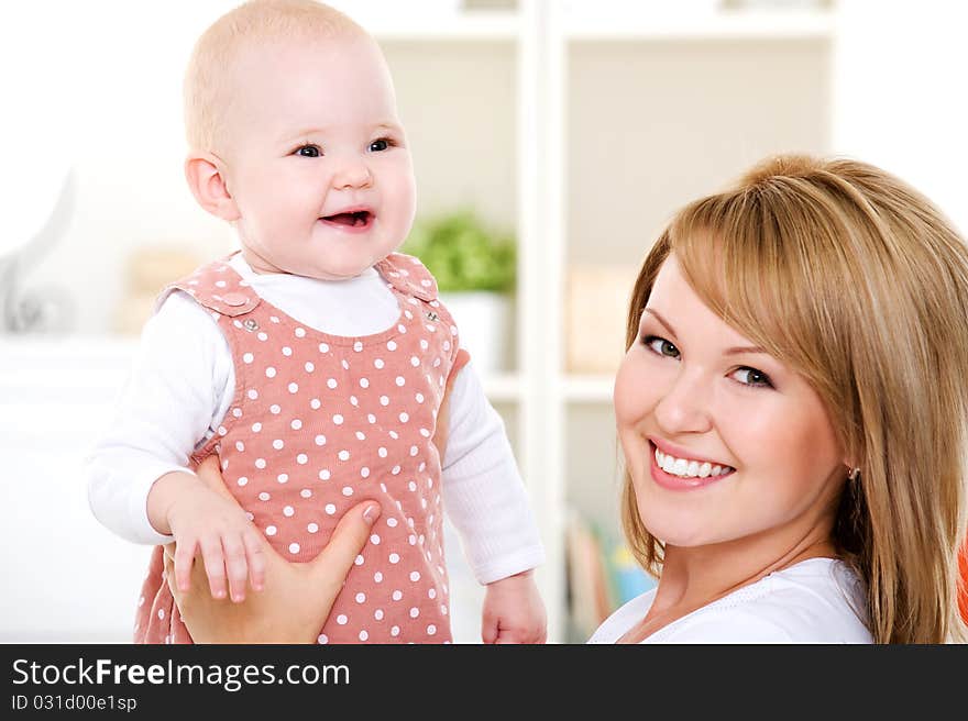 Closeup portrait of happy mother with newborn baby - indoors