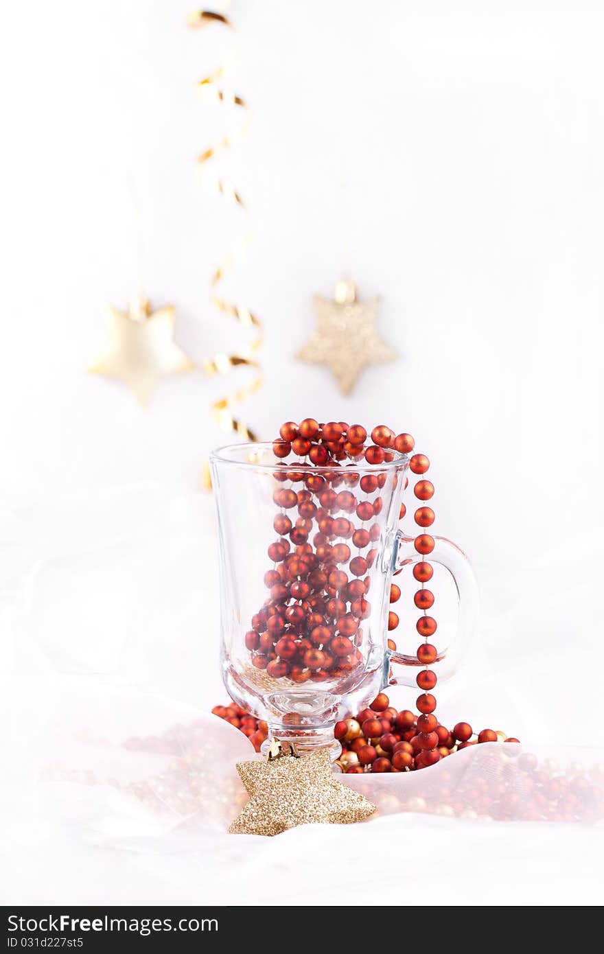 Golden christmas stars and red bow in the glass over white. Golden christmas stars and red bow in the glass over white