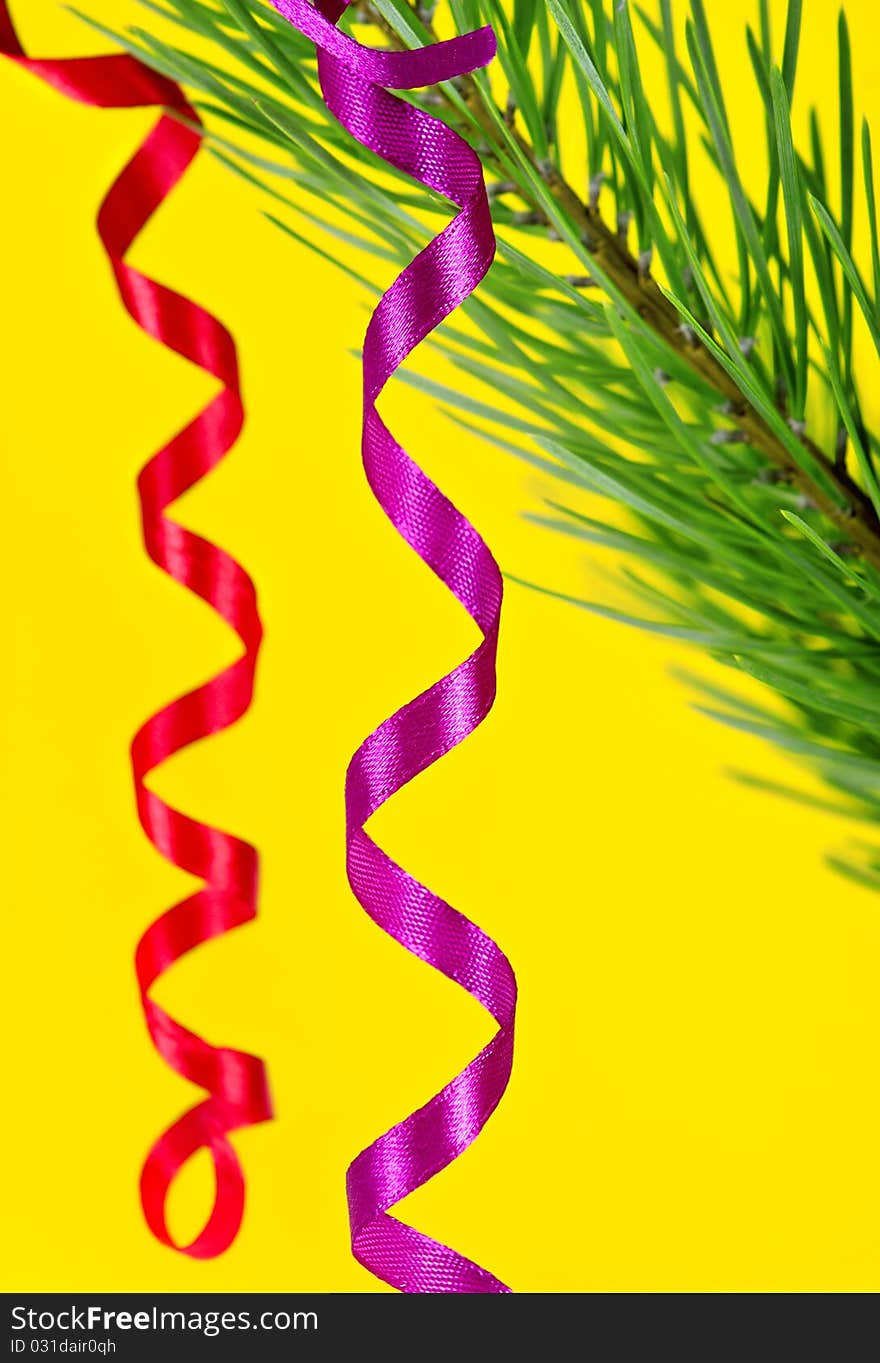 Christmas ribbons on yellow background