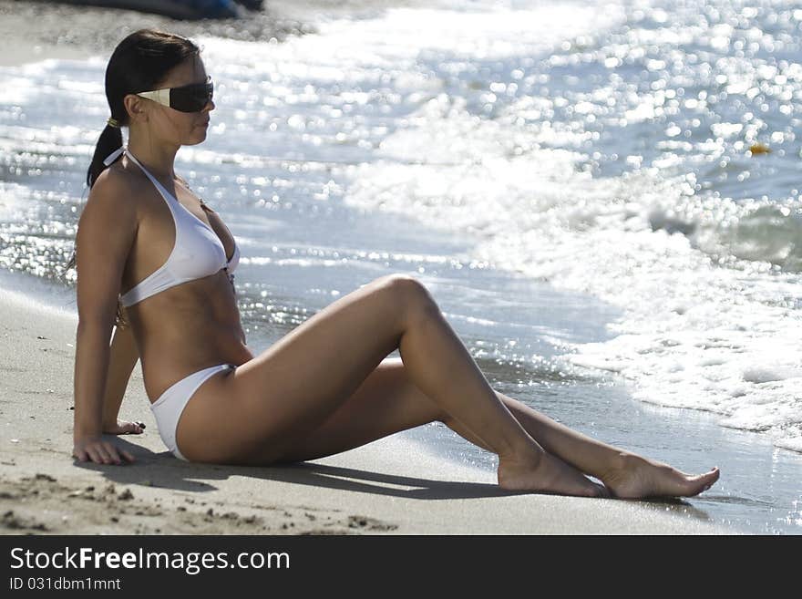 Sitting on the sand near to the sea. Sitting on the sand near to the sea