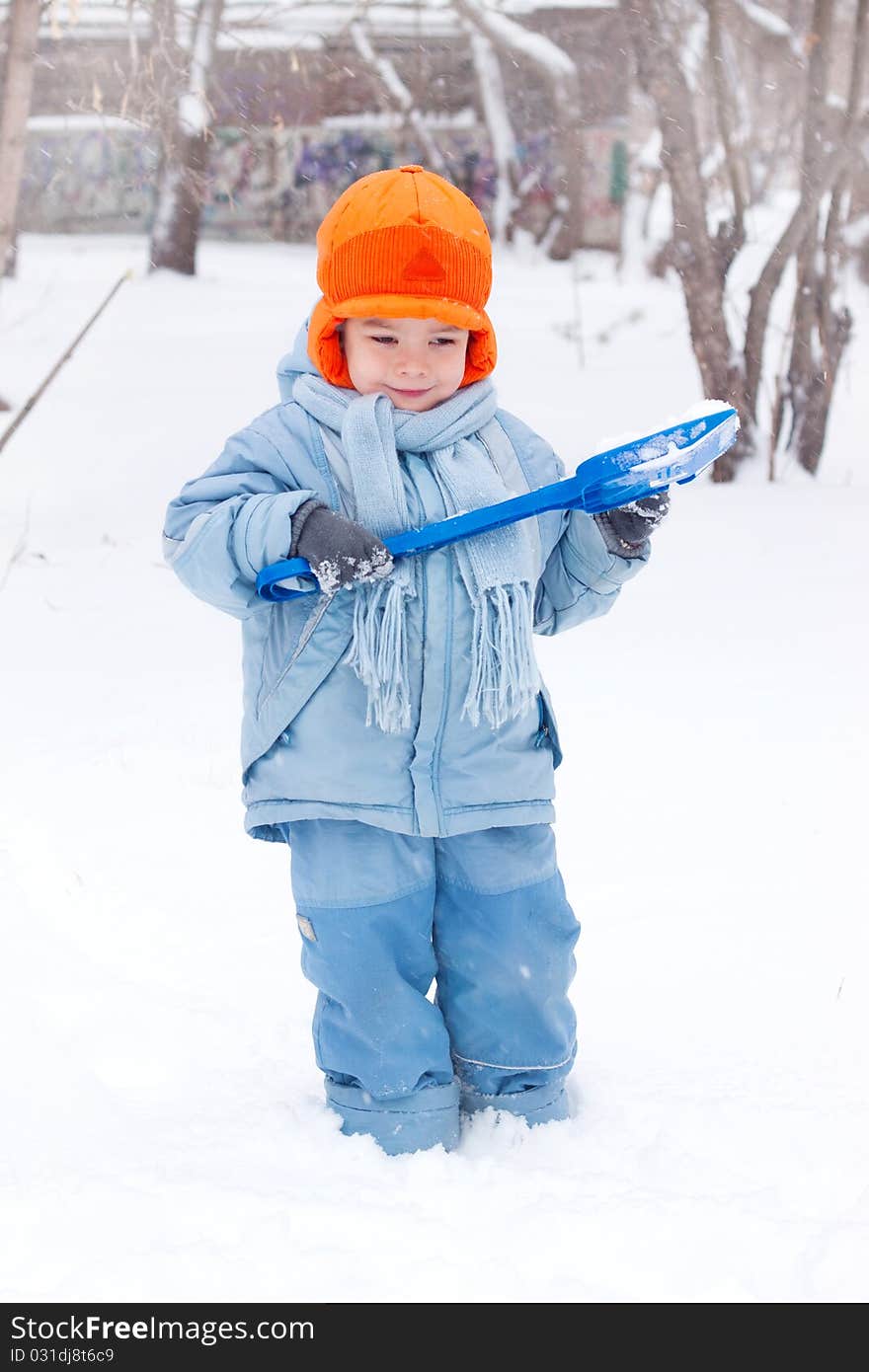 Little Boy Playing, Digs Snow