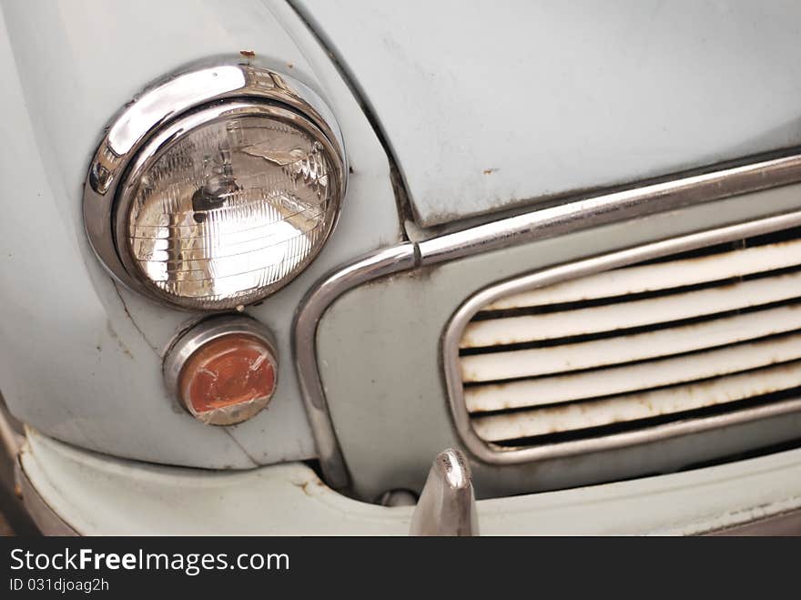 The front end of a rusty old car. The front end of a rusty old car