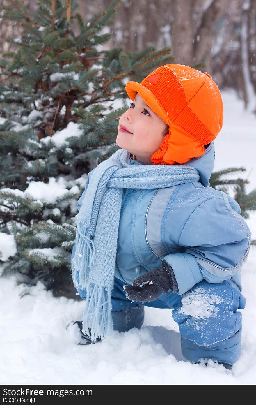 Little boy playing snowballs