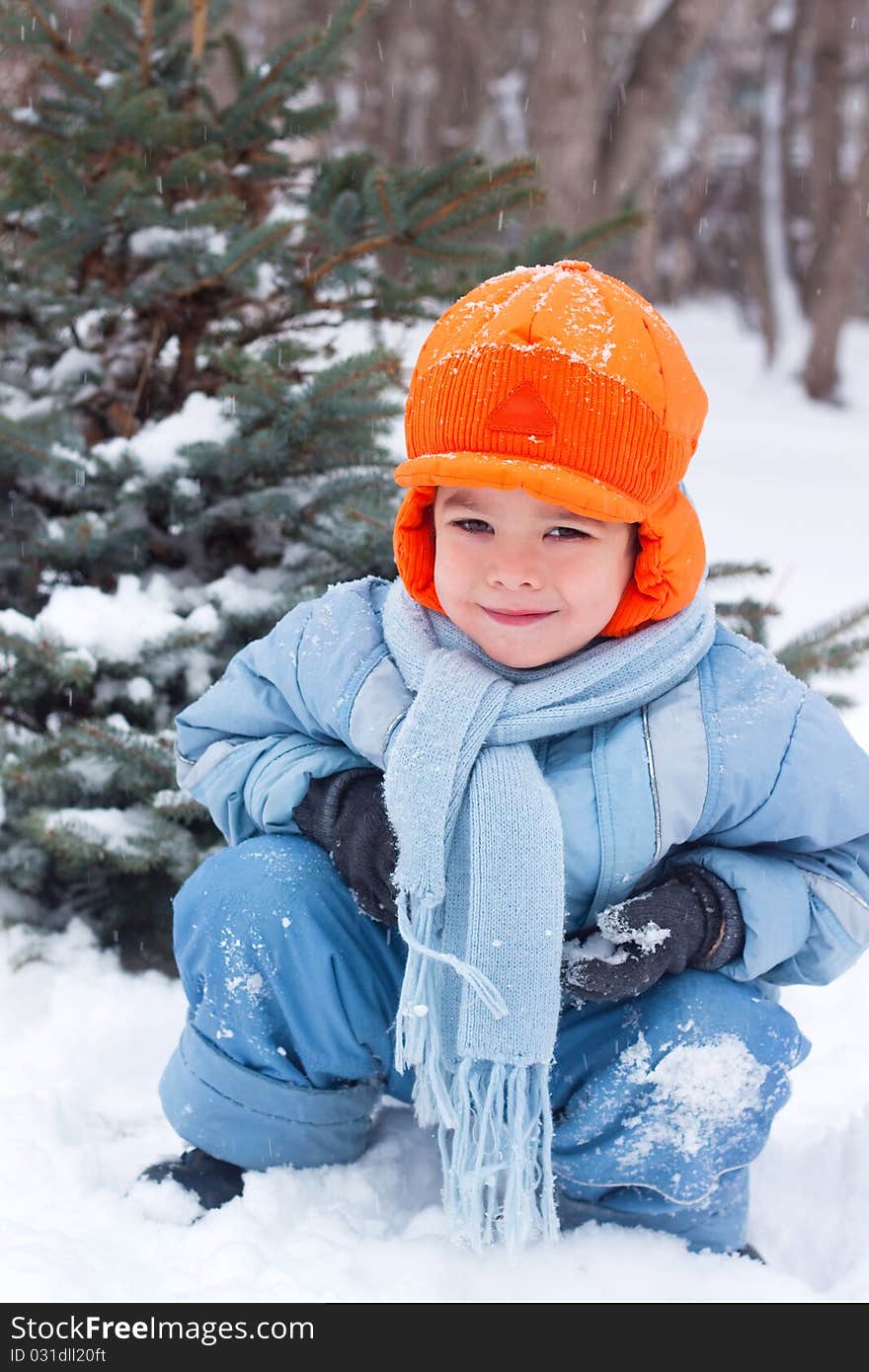 Little boy playing snowballs