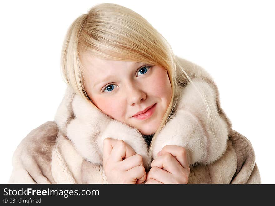 Blonde girl with blue eyes wearing a fur coat on a white background