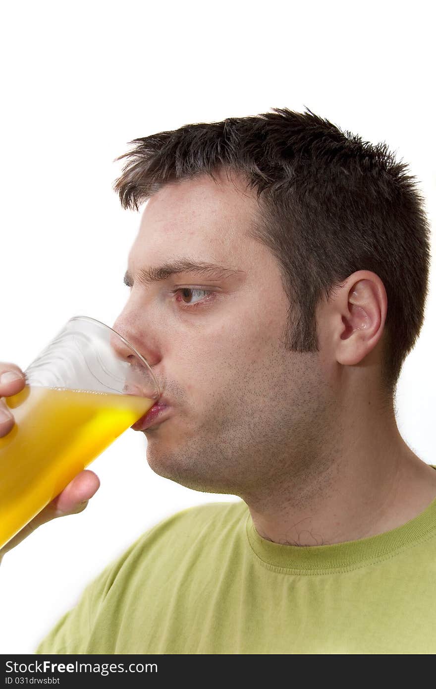 Young man drinking fruit juice from a glass, isolated on white background. Young man drinking fruit juice from a glass, isolated on white background