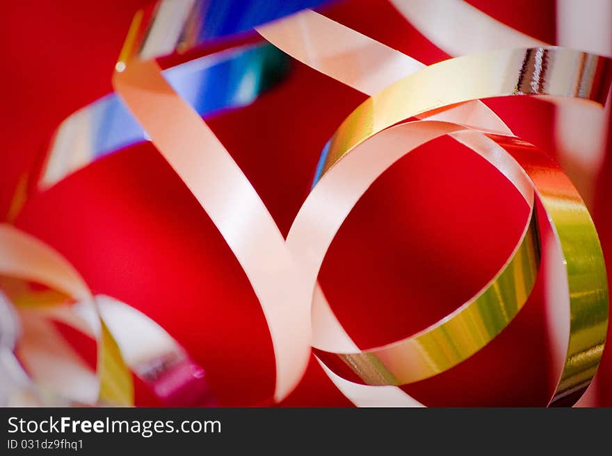 Golden christmas-tree tinsel over red. Abstract, bokeh. Golden christmas-tree tinsel over red. Abstract, bokeh