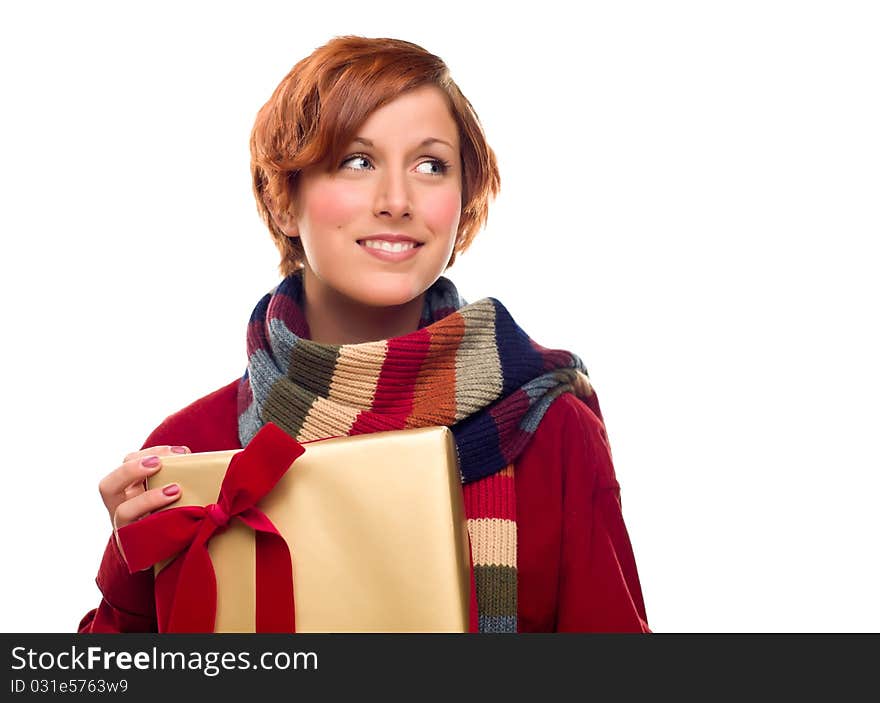 Pretty Red Haired Girl with Scarf Holding Wrapped Gift Looking Off to the Side Isolated on a White Background. Pretty Red Haired Girl with Scarf Holding Wrapped Gift Looking Off to the Side Isolated on a White Background.