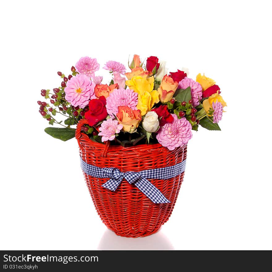 Varied colorful bouquet in an orange wicker basket isolated over white. Varied colorful bouquet in an orange wicker basket isolated over white