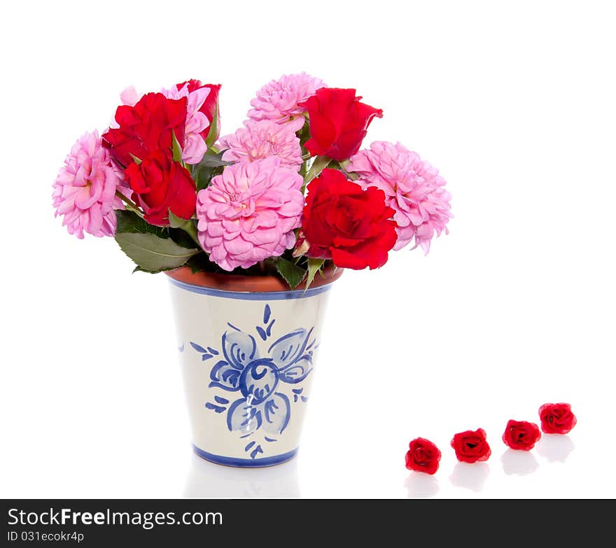 Pink Dahlia flowers  and red roses in a vase  isolated over white. Pink Dahlia flowers  and red roses in a vase  isolated over white