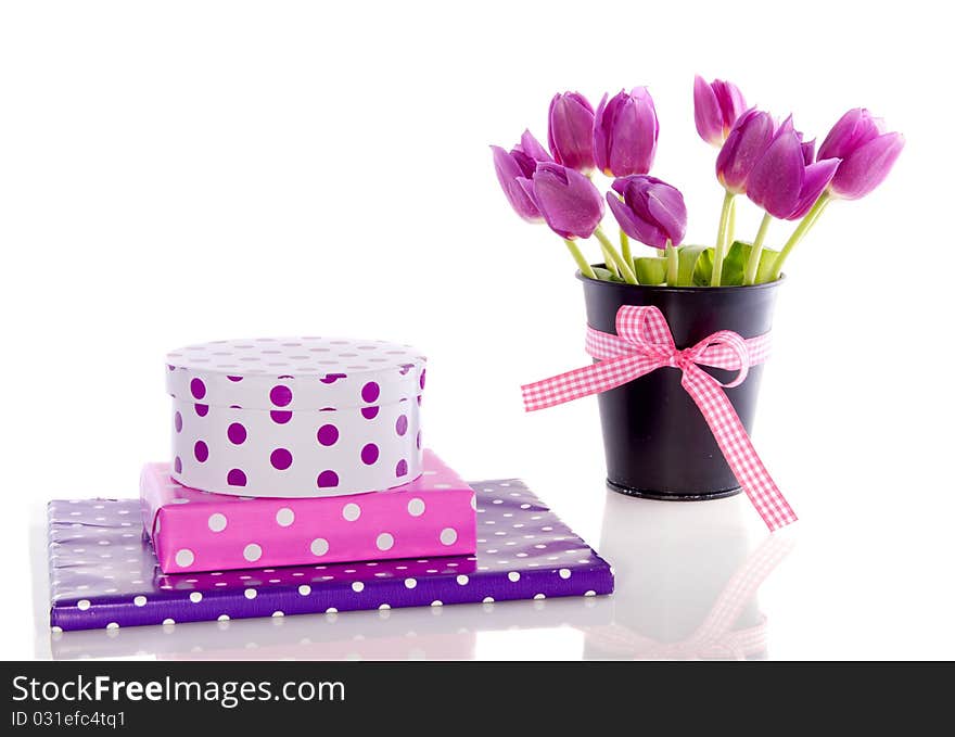 Purple tulips and colorful gifts with dots isolated over white. Purple tulips and colorful gifts with dots isolated over white