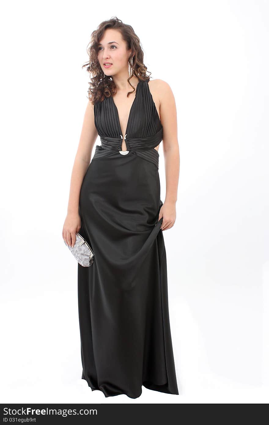 Beautiful young woman in an elegant black dress and silver purse. Beautiful young woman in an elegant black dress and silver purse