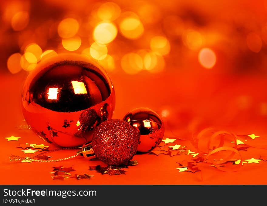 Red christmas decoration with blurred lights in the background