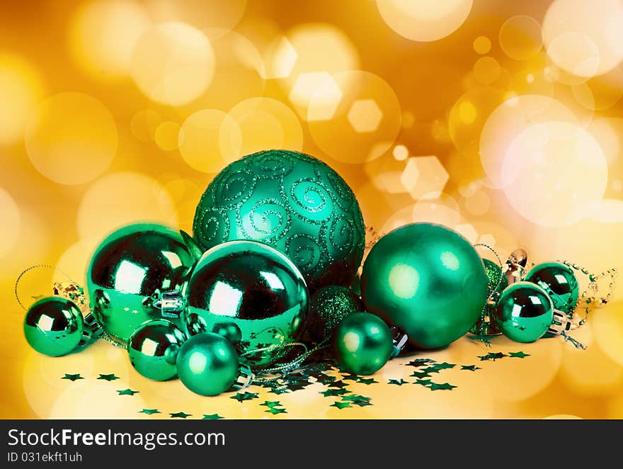 Green baubles with blurred lights in the background